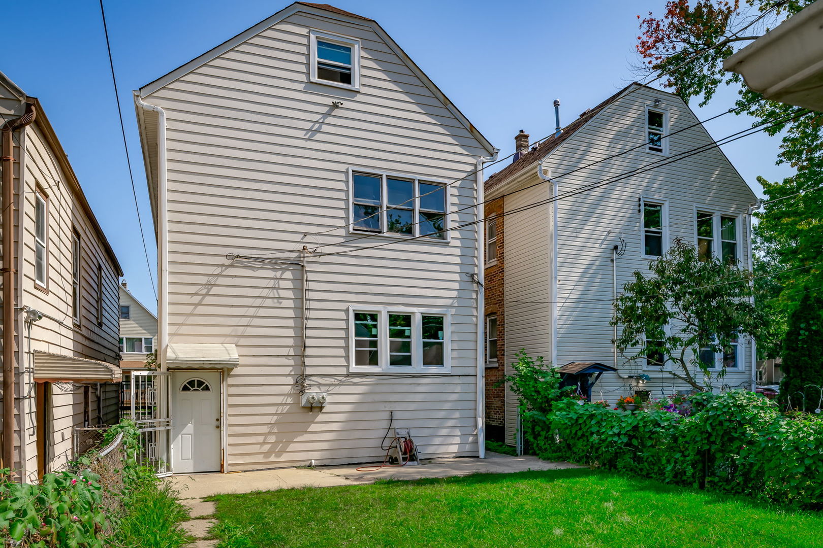 4554 South Washtenaw Avenue Chicago, IL 60632 - Photo 38 of 40 a front view of a house with a yard