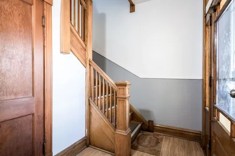 a view of entryway with wooden floor and stairs