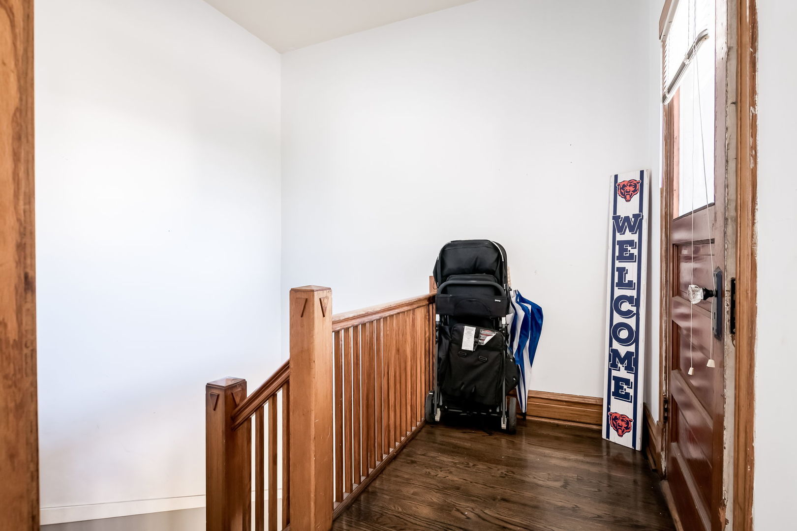 4554 South Washtenaw Avenue Chicago, IL 60632 - Photo 5 of 40 a view of a hallway with wooden floor and stairs