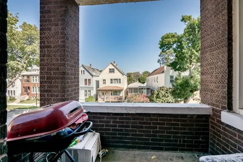 a front view of a house with outdoor seating