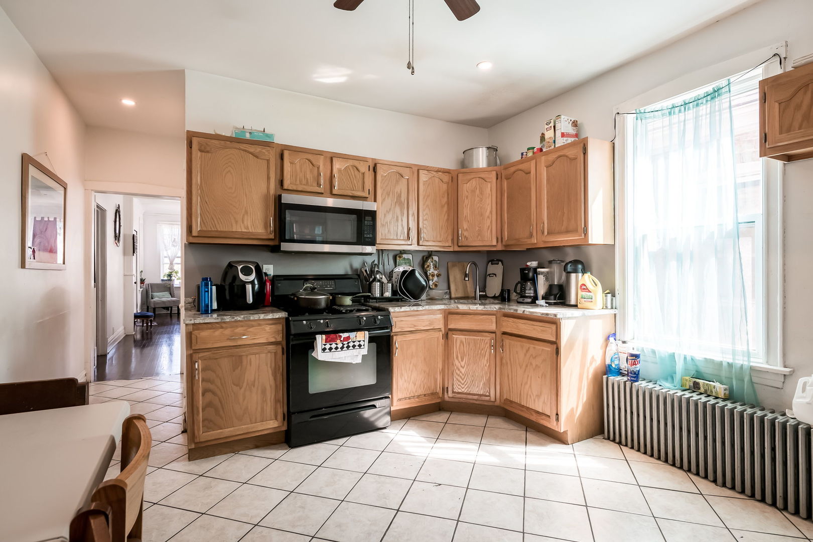 4554 South Washtenaw Avenue Chicago, IL 60632 - Photo 7 of 40 a kitchen with stainless steel appliances granite countertop a stove top oven a sink a counter top space and cabinets