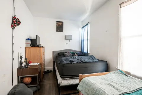 a bedroom with a bed and dresser