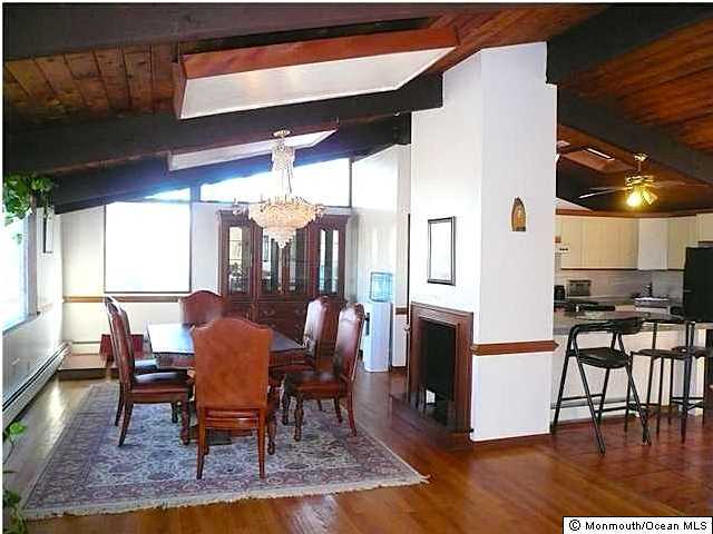 127 Stone Hill Road Colts Neck, NJ 07722 - Photo 4 of 7 a dining room with wooden floor a glass table and chairs