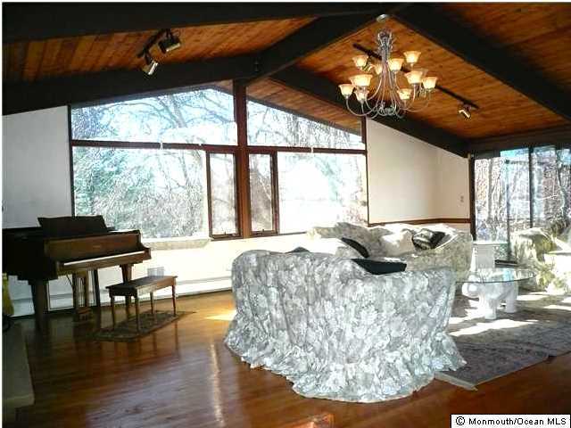 127 Stone Hill Road Colts Neck, NJ 07722 - Photo 5 of 7 a living room with furniture and a large window