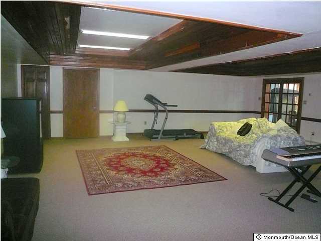 127 Stone Hill Road Colts Neck, NJ 07722 - Photo 7 of 7 a living room with table chairs and a rug