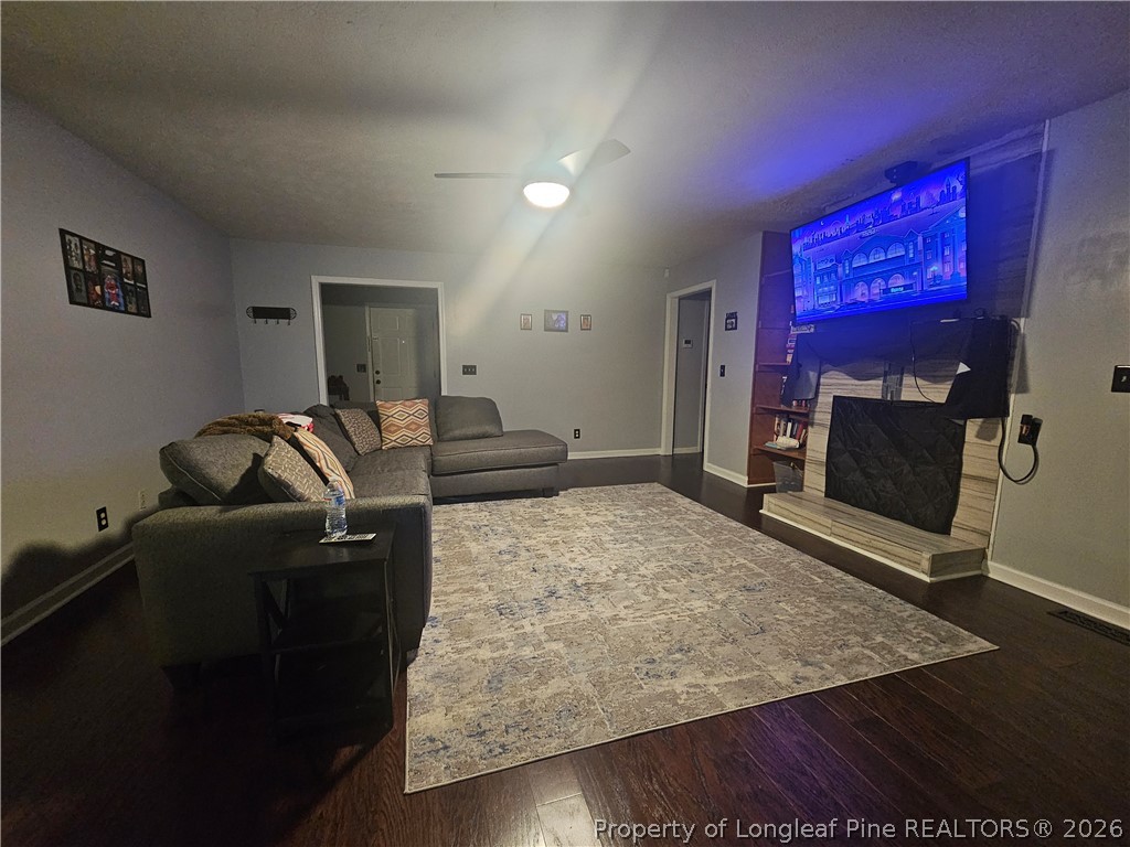 7490 Fairpoint Road Fayetteville, NC 28314 - Photo 3 of 9 a living room with furniture and a flat screen tv