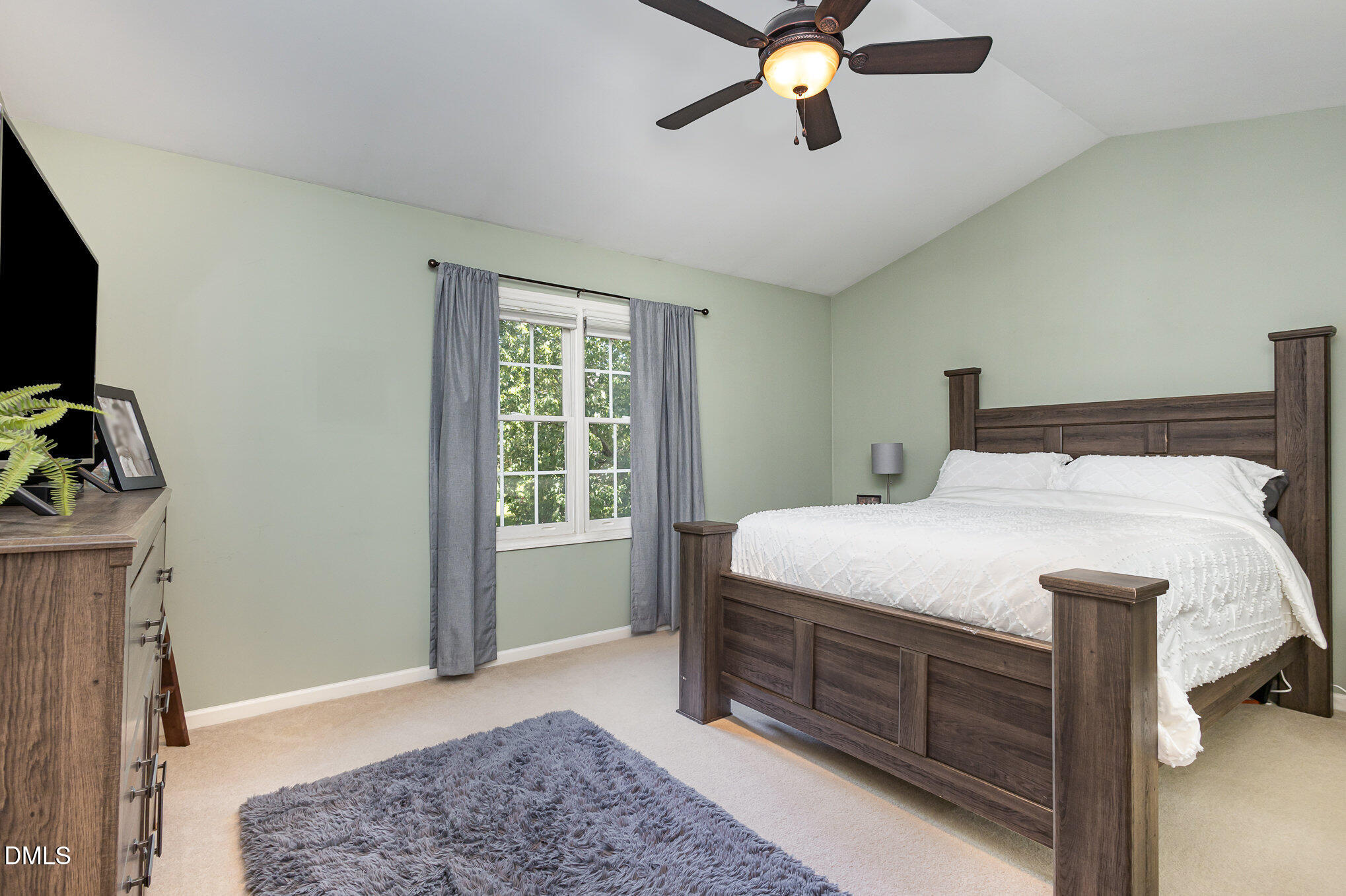 1004 Chancellors Ridge Drive Durham, NC 27713 - Photo 13 of 32 a bedroom with a bed and a chandelier