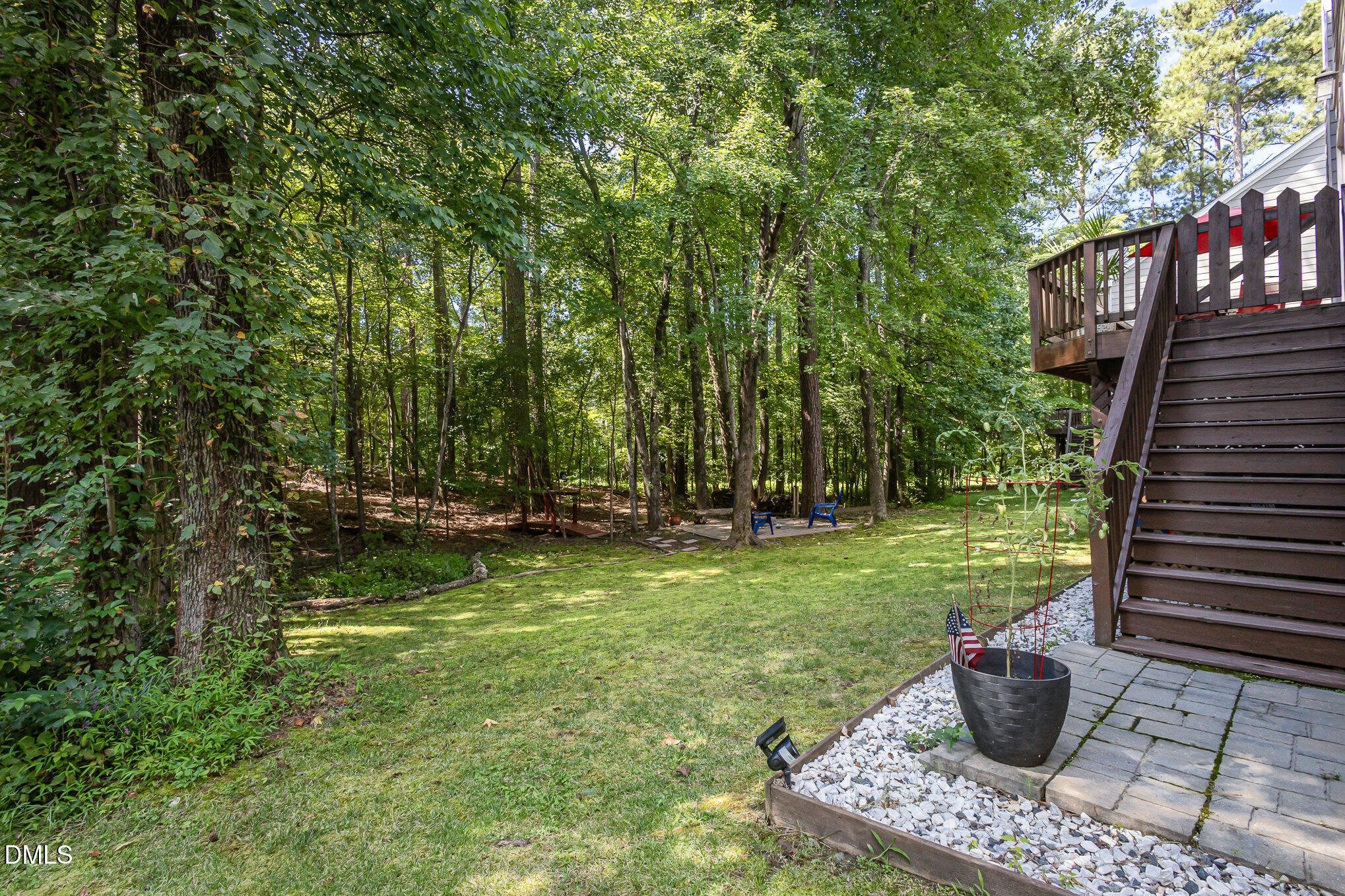 1004 Chancellors Ridge Drive Durham, NC 27713 - Photo 22 of 32 a view of a garden with potted plants and large trees
