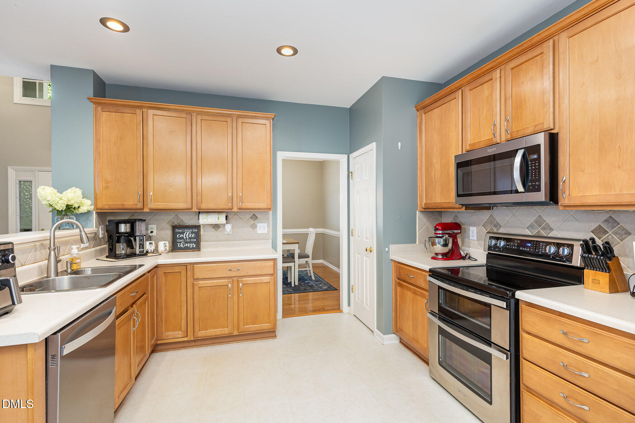 1004 Chancellors Ridge Drive Durham, NC 27713 - Photo 4 of 32 a kitchen with stainless steel appliances a stove sink microwave and cabinets