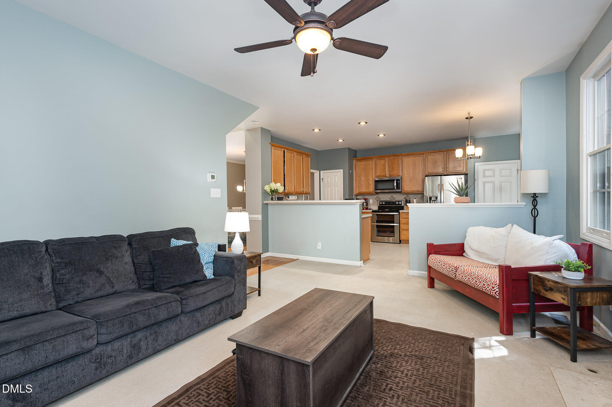 1004 Chancellors Ridge Drive Durham, NC 27713 - Photo 6 of 32 a living room with furniture kitchen view and a chandelier
