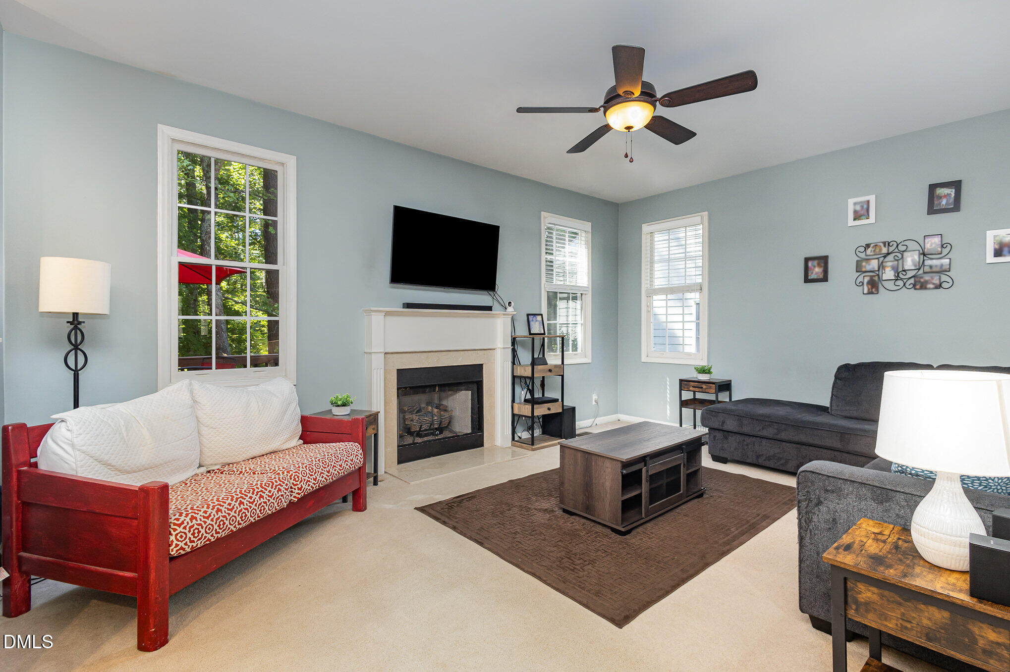 1004 Chancellors Ridge Drive Durham, NC 27713 - Photo 7 of 32 a living room with furniture a flat screen tv and a fireplace