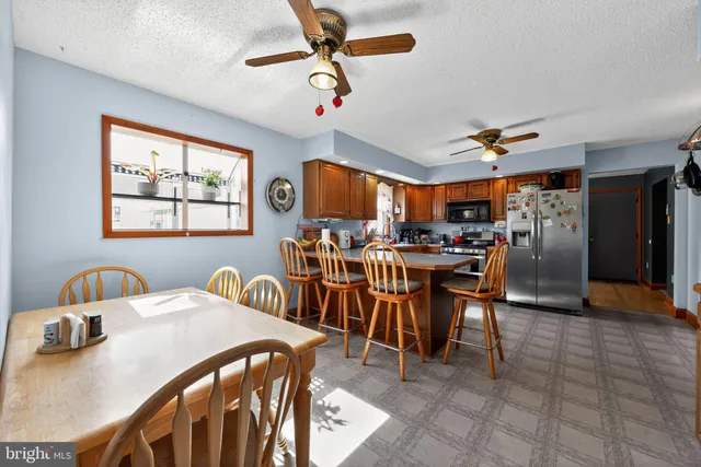 a view of a dining room with furniture and a chandelier