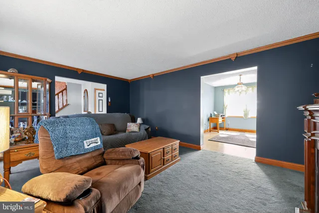 a bedroom with furniture and a large window