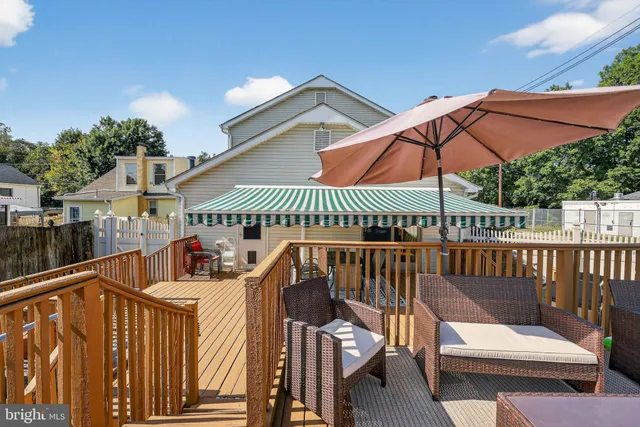 a view of a roof deck with chair and wooden floor
