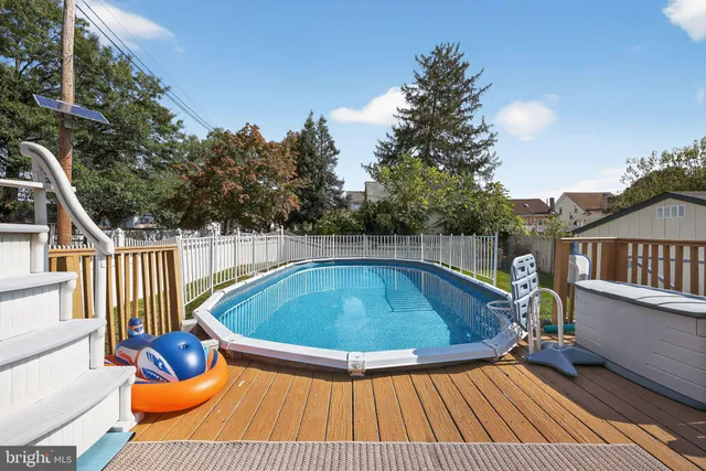 a view of a roof deck with couches and wooden floor