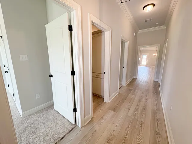 a view of a hallway with wooden floor