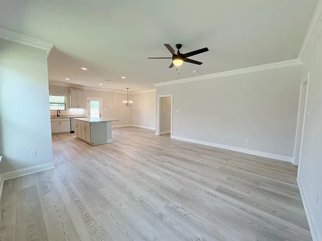 a view of a room with wooden floor and windows