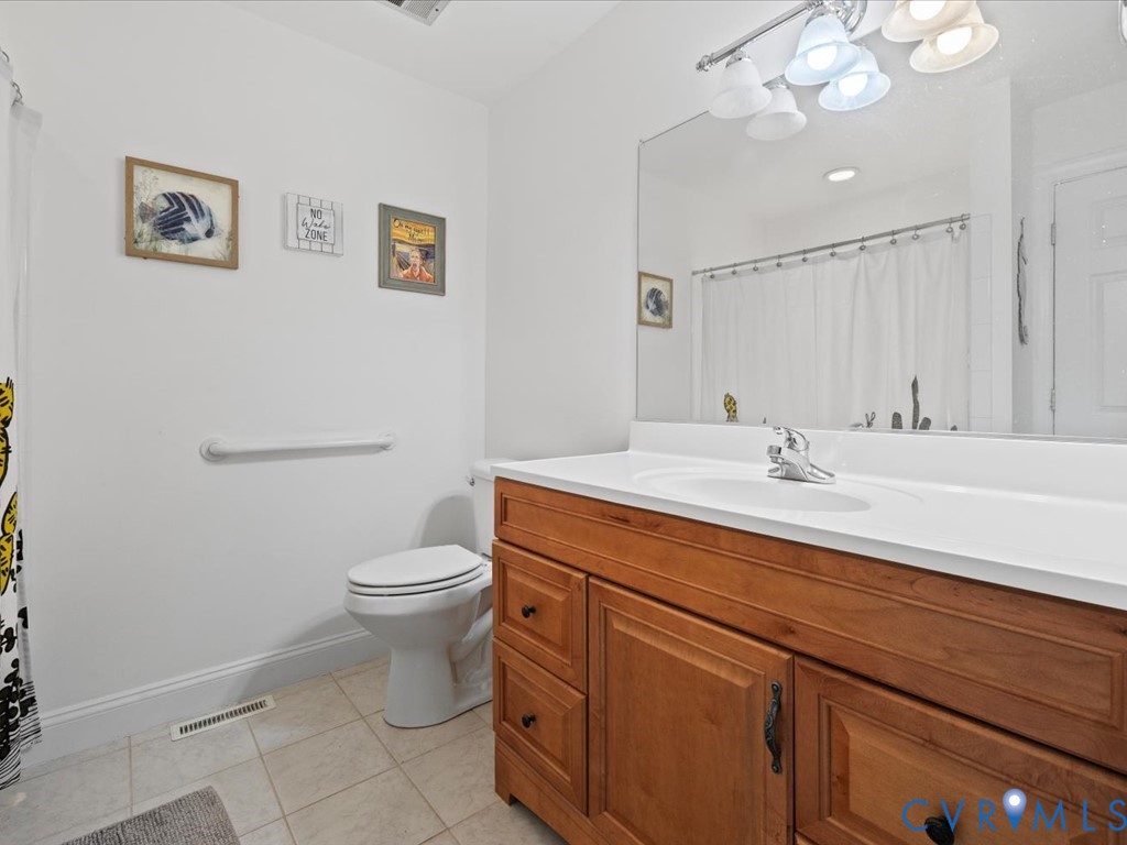 222 Homestead Drive Colonial Heights, VA 23834 - Photo 18 of 35 a bathroom with a toilet sink and mirror