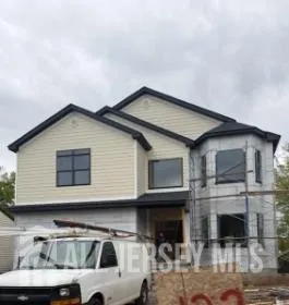a front view of a house with parking space