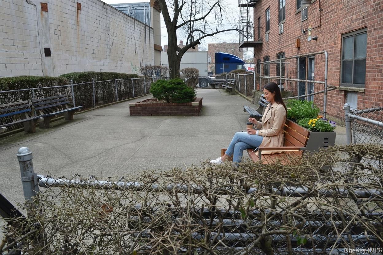 99-10 60th Avenue, Unit 5D Queens, NY 11368 - Photo 8 of 9 a backyard of a house with outdoor seating