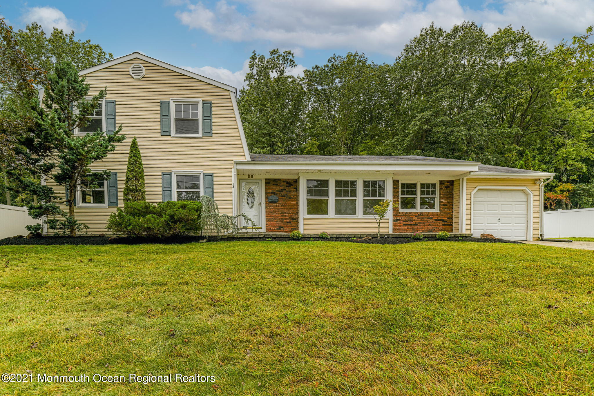 56 Newbury Road Howell, NJ 07731 - Photo 1 of 32 a front view of a house with a garden