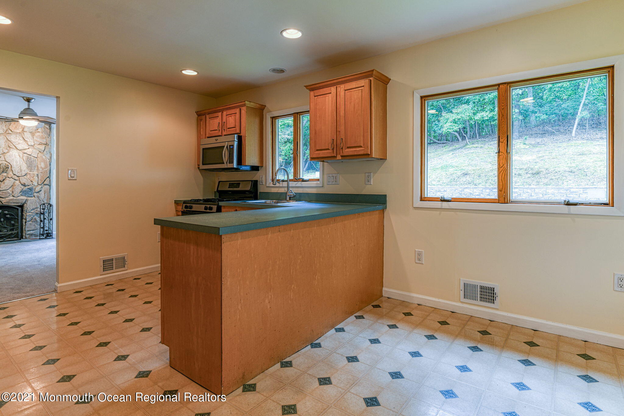 56 Newbury Road Howell, NJ 07731 - Photo 13 of 32 a kitchen with granite countertop a sink a stove top oven a granite counter space and windows