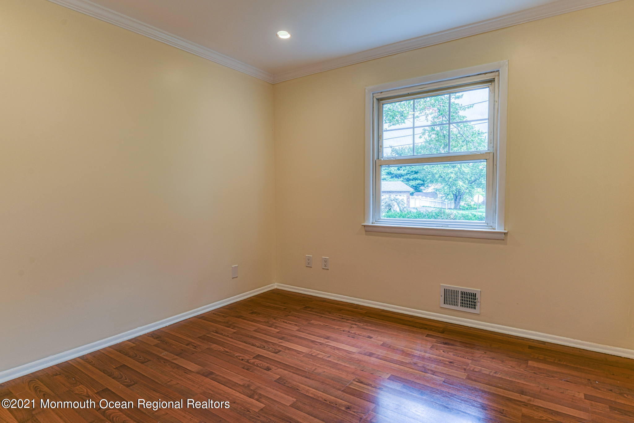 56 Newbury Road Howell, NJ 07731 - Photo 19 of 32 a view of an empty room with wooden floor and a window