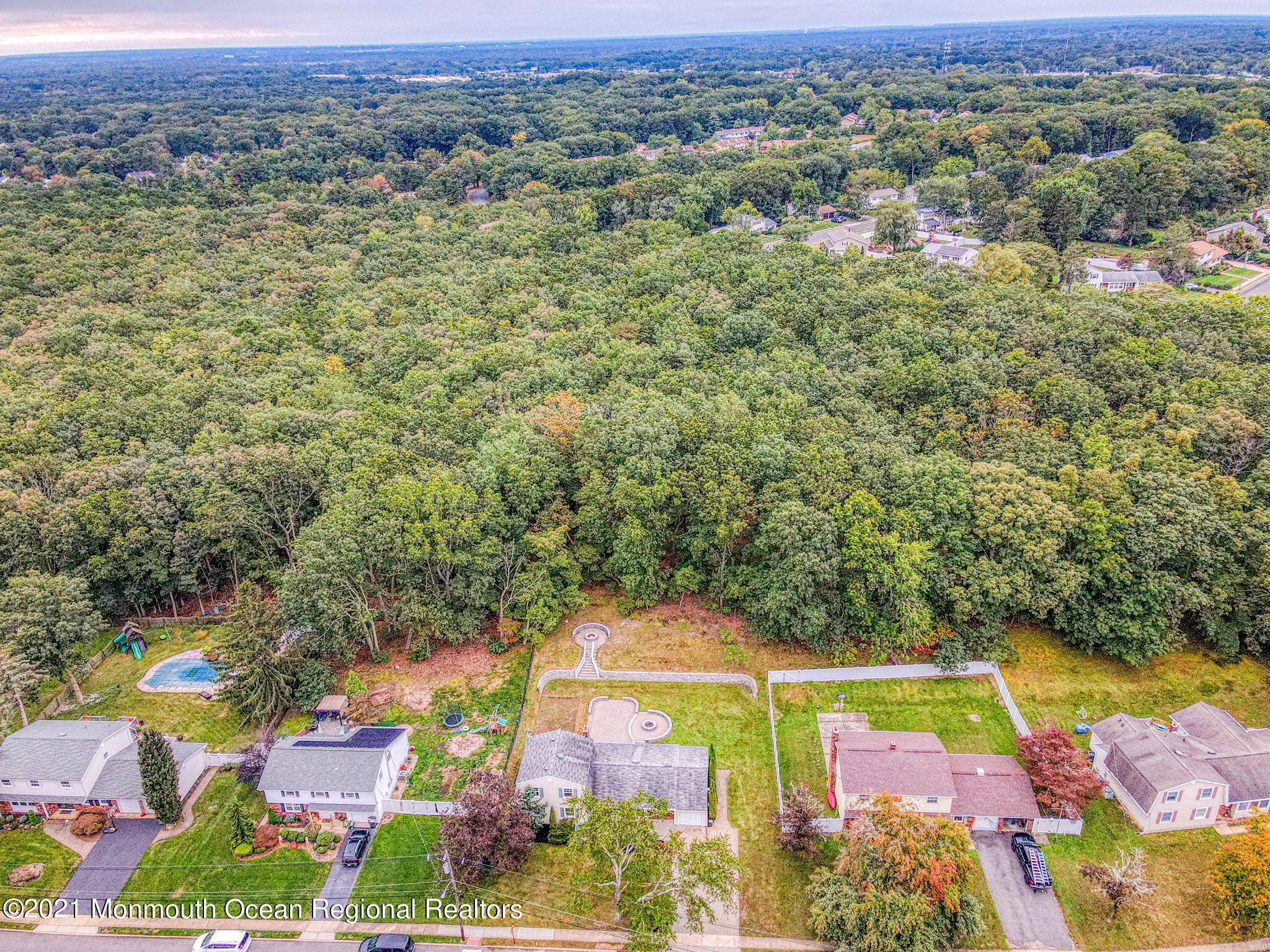 56 Newbury Road Howell, NJ 07731 - Photo 32 of 32 an aerial view of residential houses with outdoor space and swimming pool