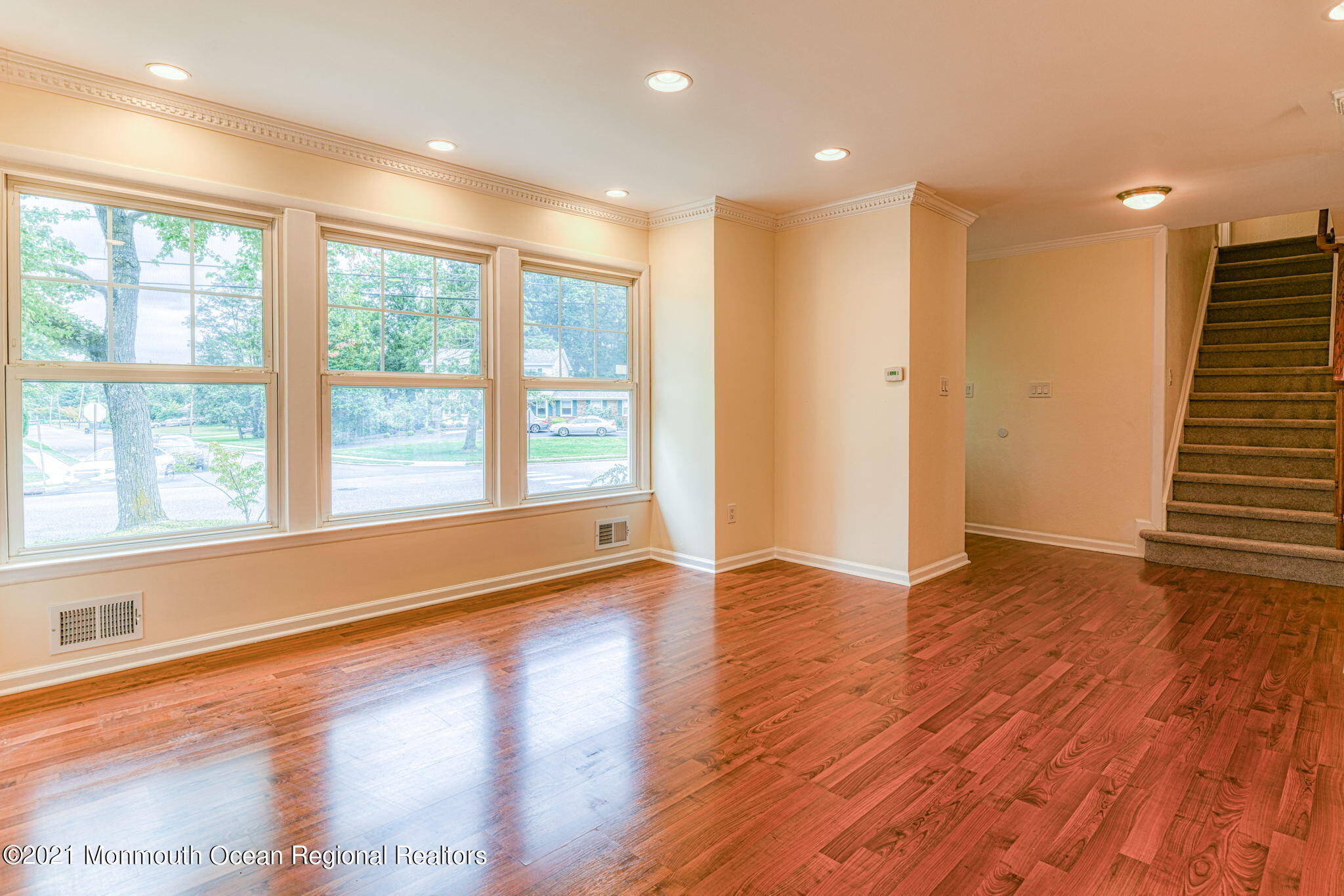 56 Newbury Road Howell, NJ 07731 - Photo 6 of 32 a view of an empty room with wooden floor and a window