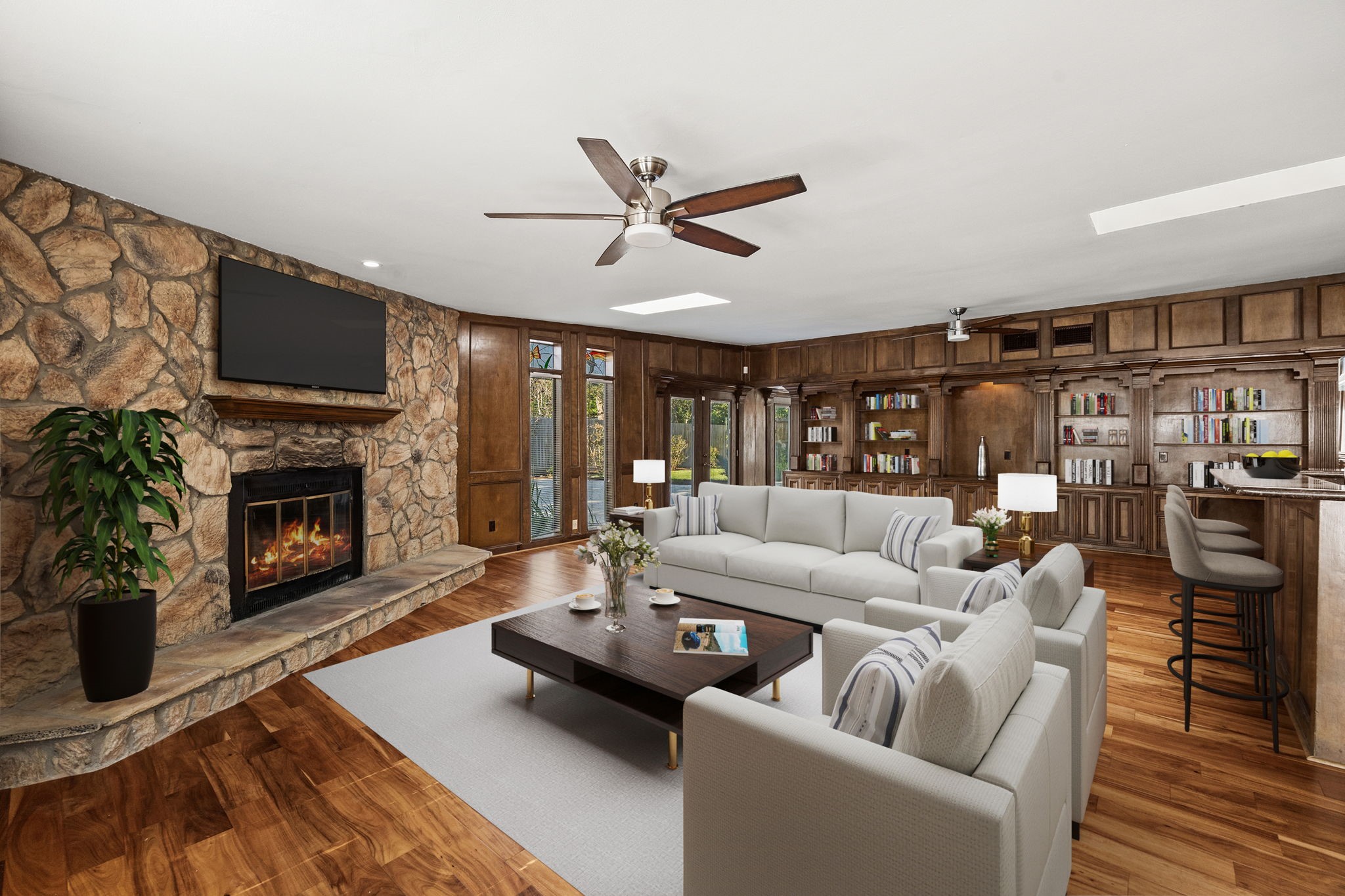 10310 Mayfield Road Houston, TX 77043 - Photo 15 of 49 View of beautiful wood floors in family room, rock wall with fireplace, built-ins, french doors to covered outdoor area (Virtually staged)