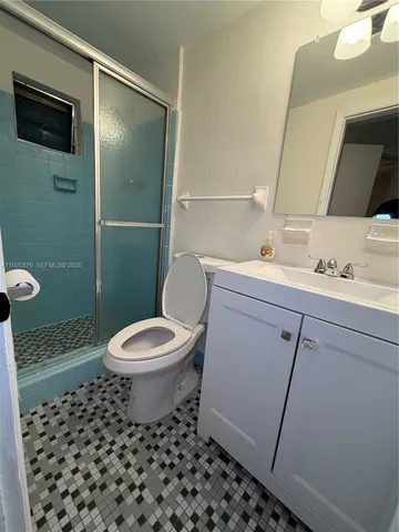 a bathroom with a toilet a sink and a mirror