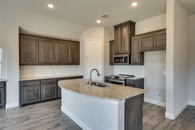 a view of a kitchen with an oven and refrigerator