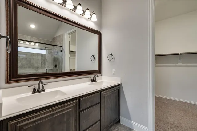 a bathroom with a shower sink and mirror