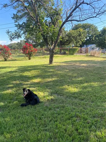 a backyard of a house with lots of green space and lake view