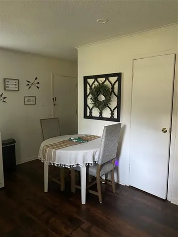 a view of a dining room with furniture wooden floor and window