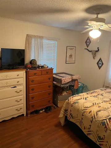 a bedroom with a bed and flat screen tv