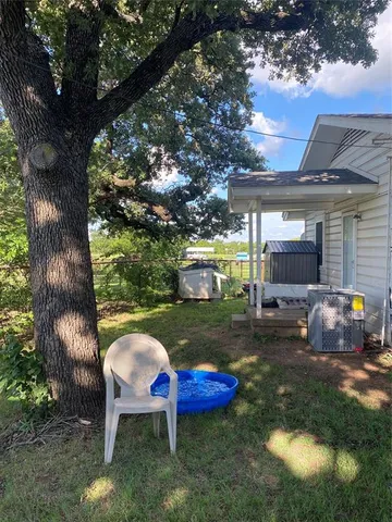 a backyard of a house with table and chairs