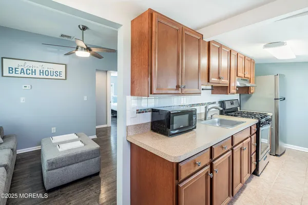 a kitchen with a sink cabinets and a stove top oven