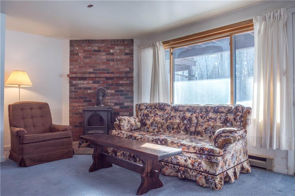 137 Ridge Run Road, Unit E2 Newry, ME 04261 - Photo 14 of 22 Wood stove in the lower level.