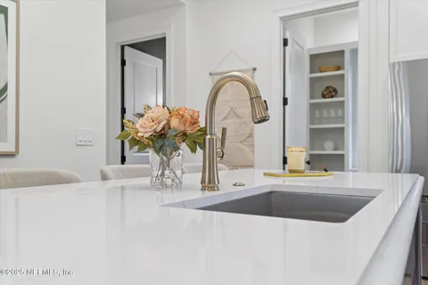 a bathroom with a sink a vanity and a large mirror