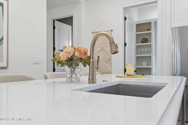 a bathroom with a sink a vanity and a large mirror