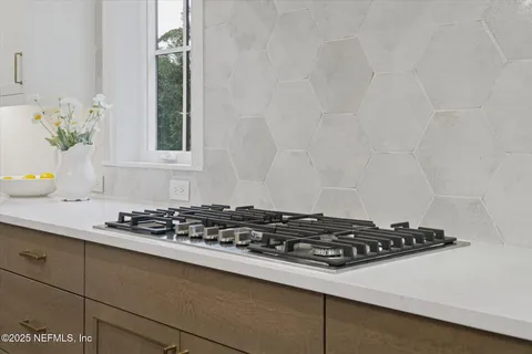 a stove top oven sitting inside of a kitchen