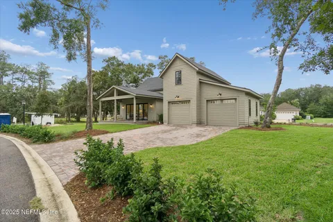 a view of a house with yard and porch