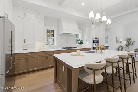 a kitchen with a table chairs sink and cabinets
