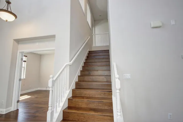 an empty room with window and bathroom