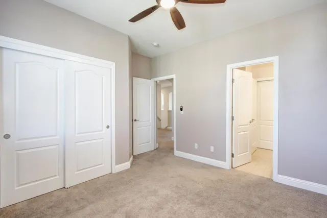 a spacious bathroom with a granite countertop double vanity sink large mirror and bathtub