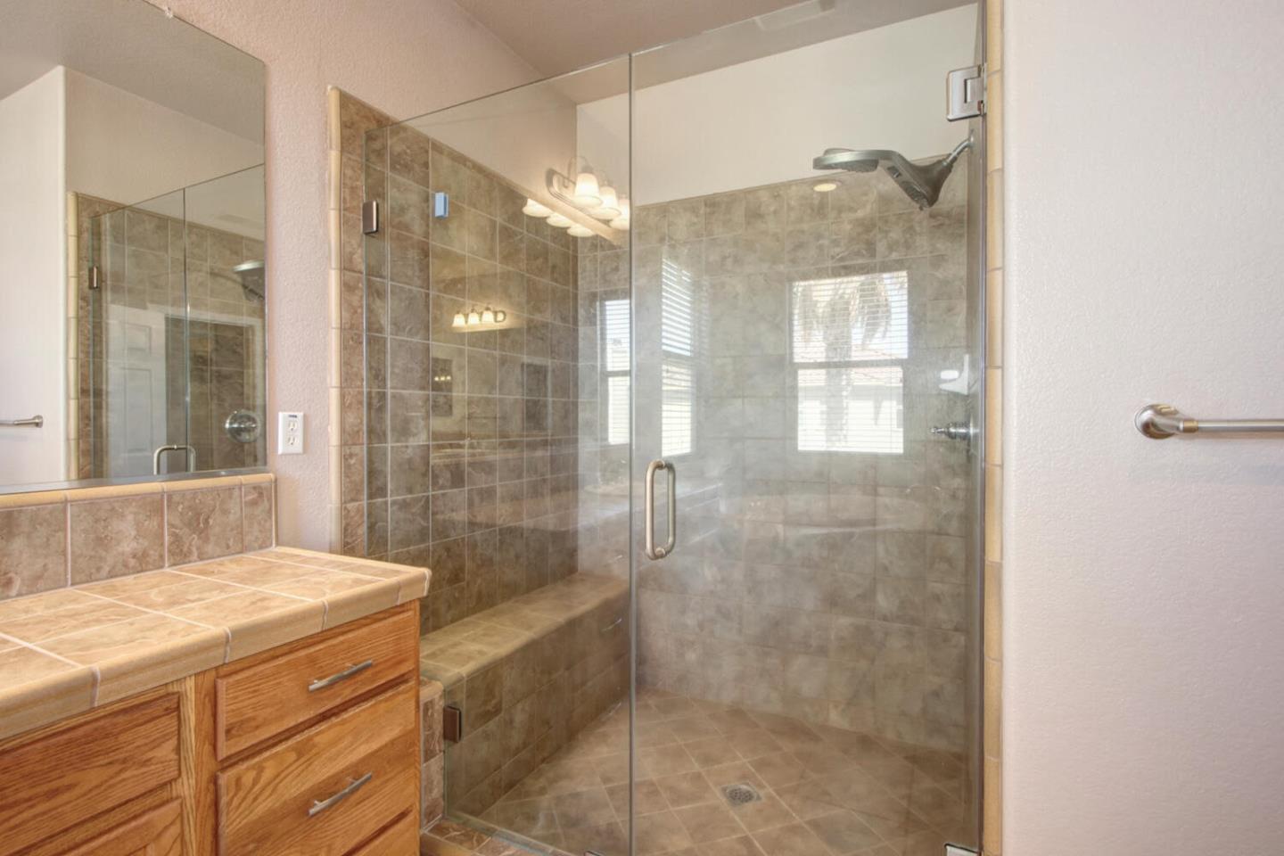 9987 Spring View Way Elk Grove, CA 95757 - Photo 20 of 28 a bathroom with a granite countertop shower sink and mirror