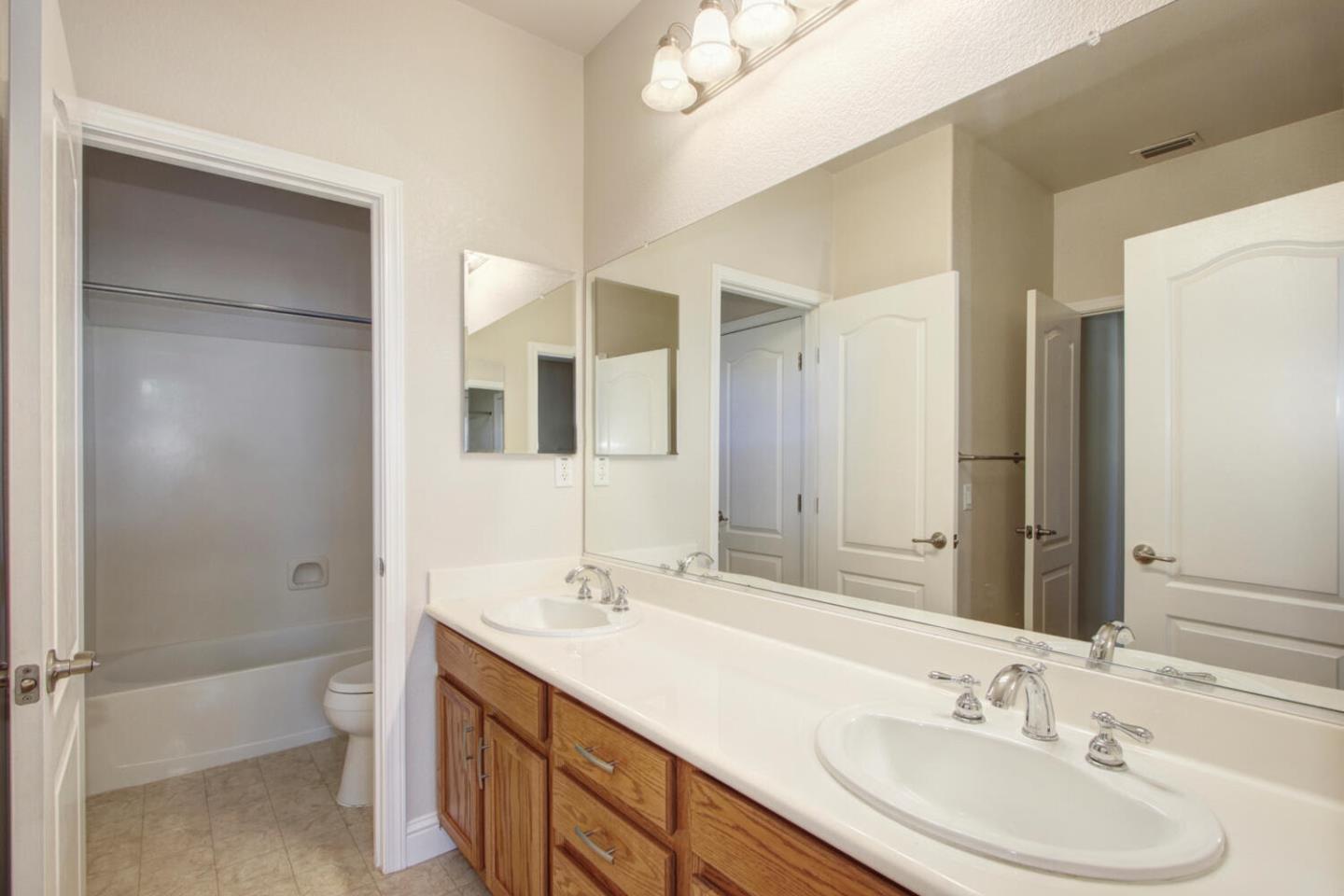 9987 Spring View Way Elk Grove, CA 95757 - Photo 23 of 28 a bathroom with a sink a toilet and shower