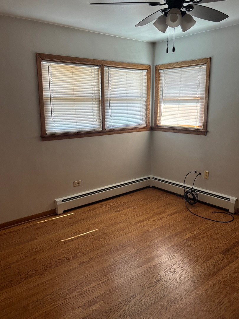 6401 West 52nd Street, Unit 2 Chicago, IL 60638 - Photo 8 of 16 wooden floor in an empty room with a window