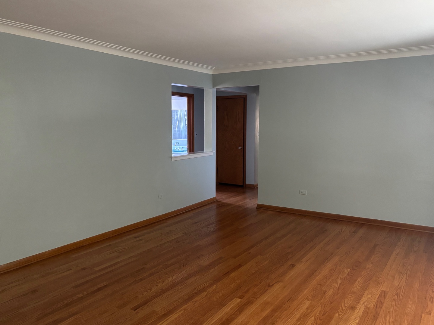 6401 West 52nd Street, Unit 2 Chicago, IL 60638 - Photo 12 of 16 a view of an empty room with wooden floor and a window